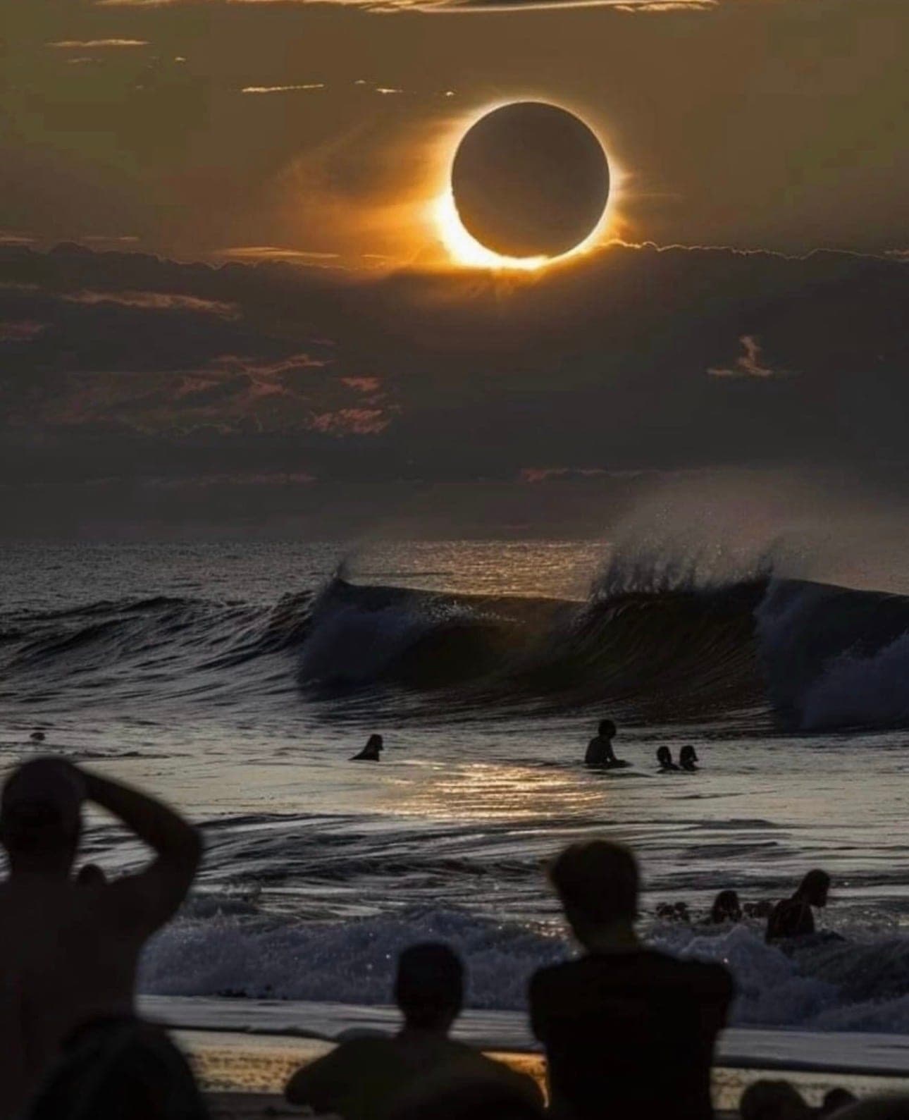 Totality over the water, and everyone who came to watch.